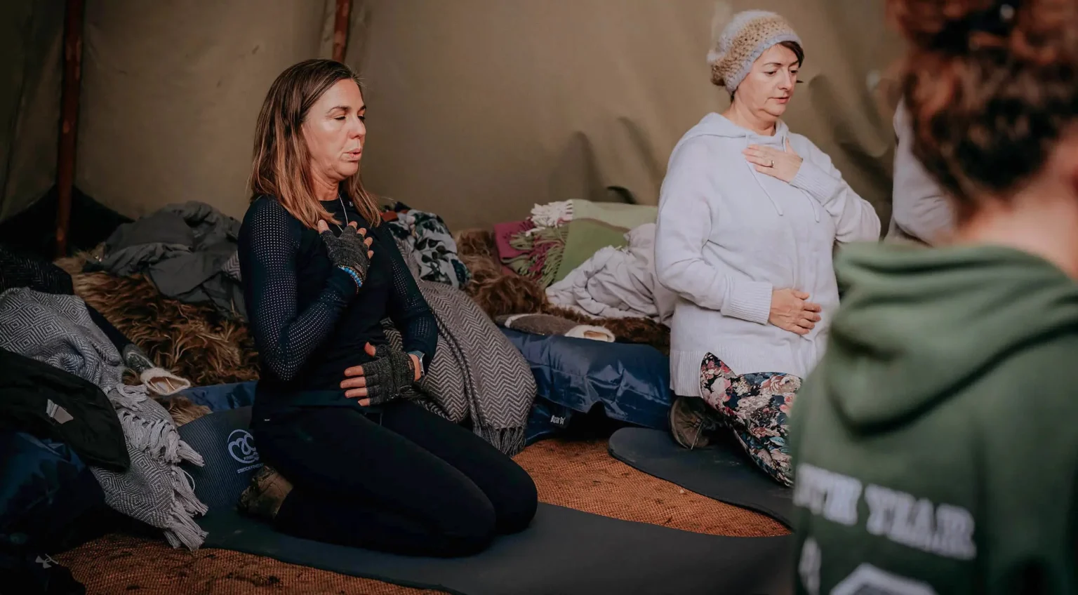 Women engaged in a deep breathing session at the Nourish Wellness Retreat, held at Swinton Estate.