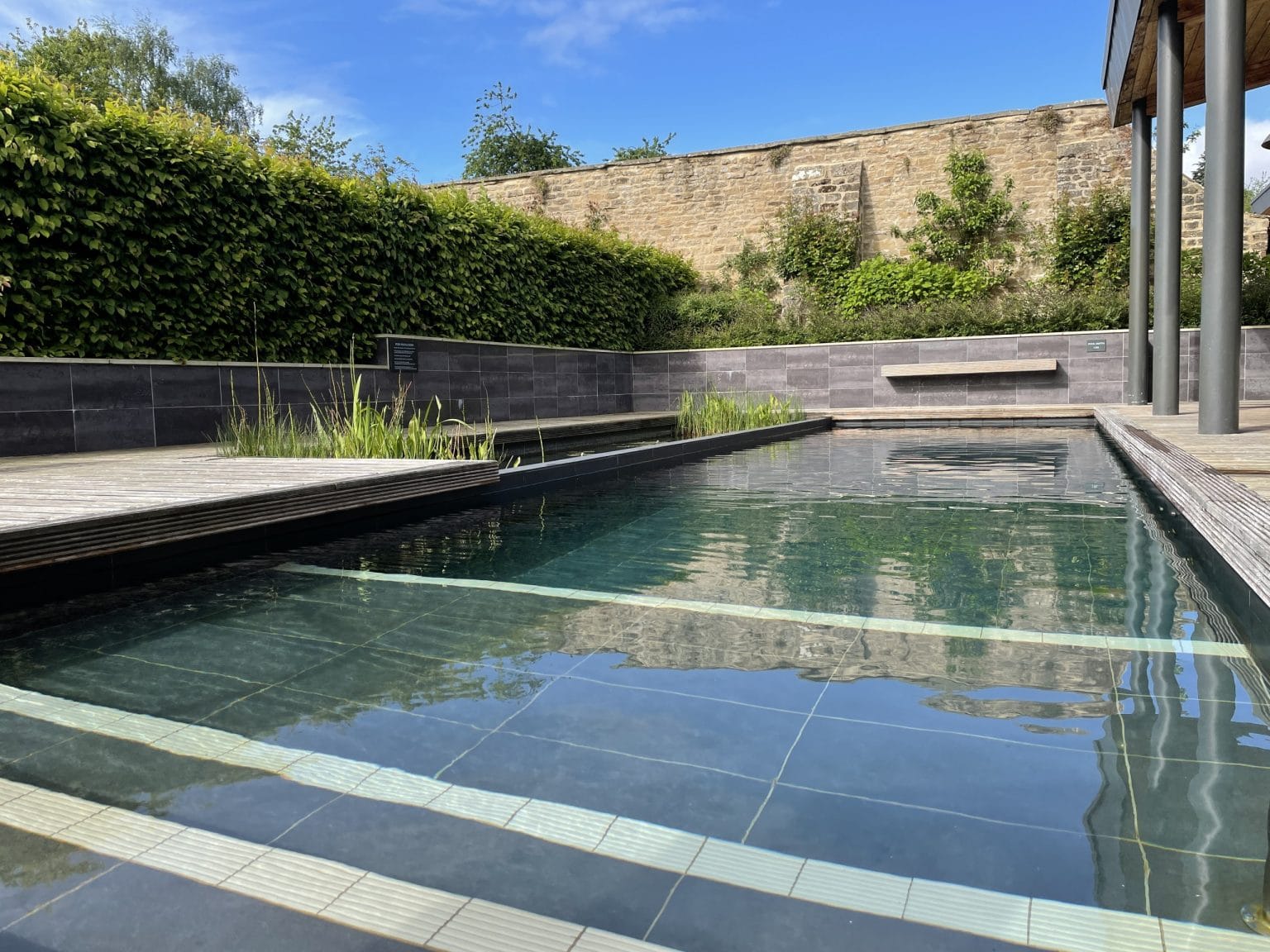 Outdoor pool at Swinton Country Club offering relaxation and wellness facilities with surrounding greenery